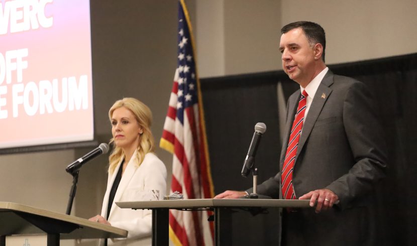 This is a picture of attorney general candidates Katherine Robertson and Jay Mitchell standing at podiums.