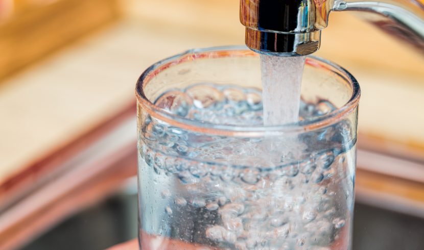 This is a picture of a glass being filled with water from a faucet.