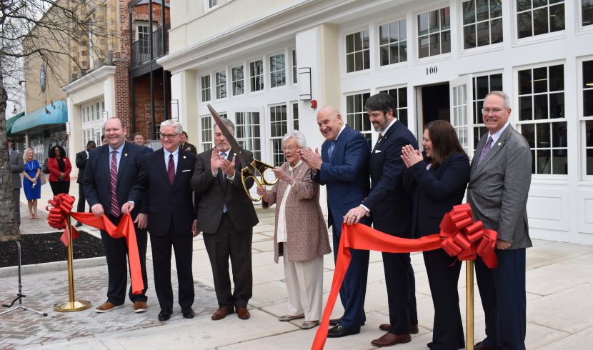 This is a picture of Kay Ivey cutting a ceremonial ribbon.