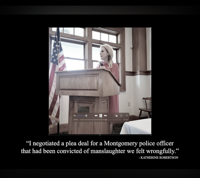 This is a screenshot from the ad of Robertson speaking at a podium.