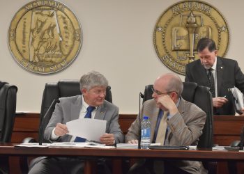 This is a picture of Greg Albritton talking to Clyde Chambliss.