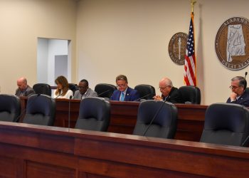 This is a picture of people sitting at a dais in Room 200 in the Alabama State House