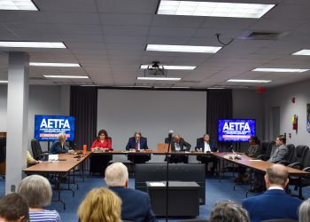This is a wide shot of the board meeting