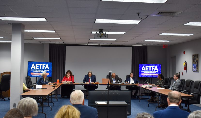 This is a wide shot of the board meeting