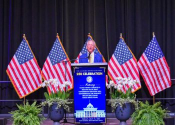 This is a picture of Tommy Tuberville speaking on a stage