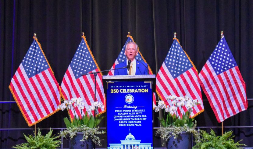 This is a picture of Tommy Tuberville speaking on a stage
